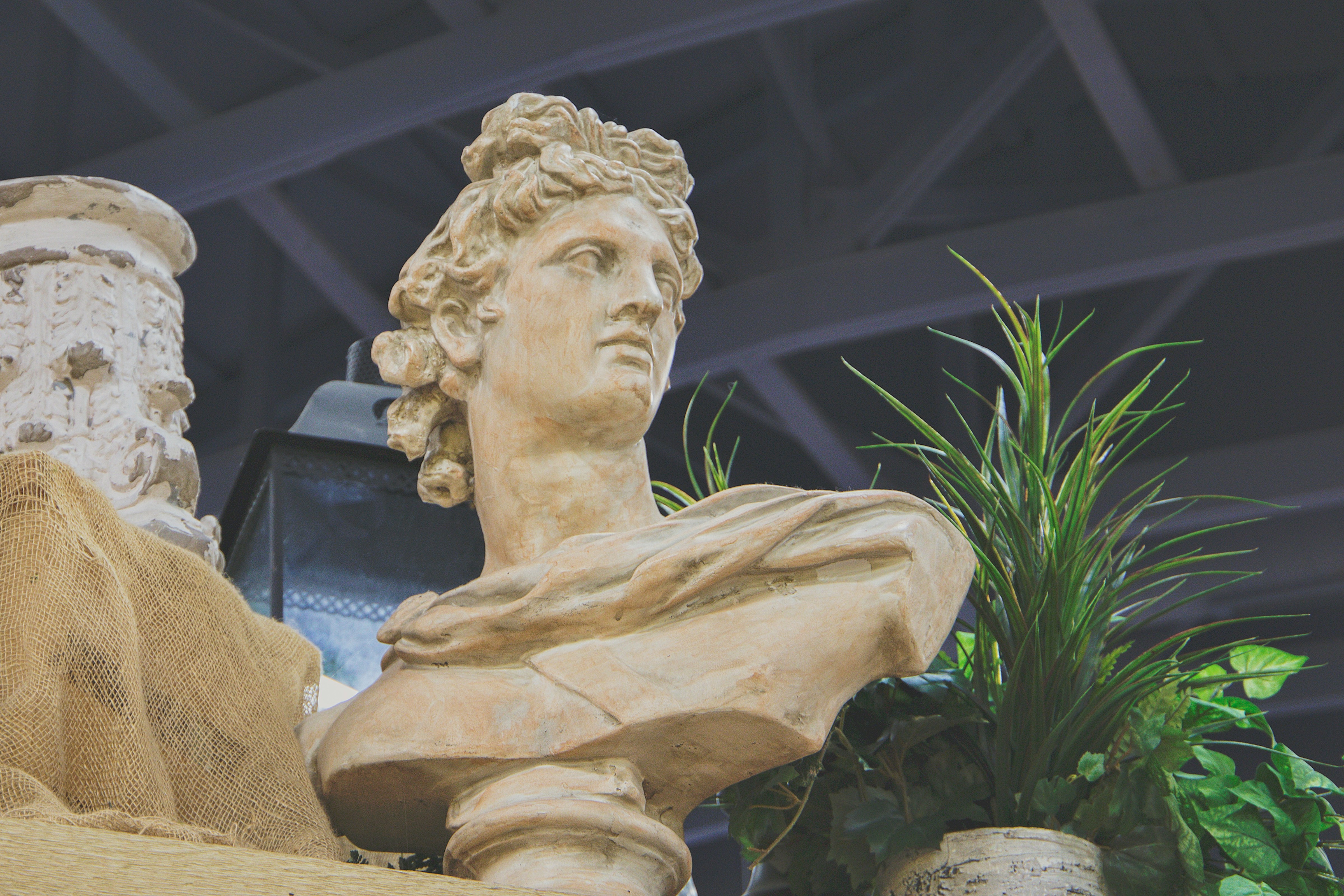 Image of an old greek statue of Socrates, symbolizing the art of Socratic dialogue and transformative discourse.