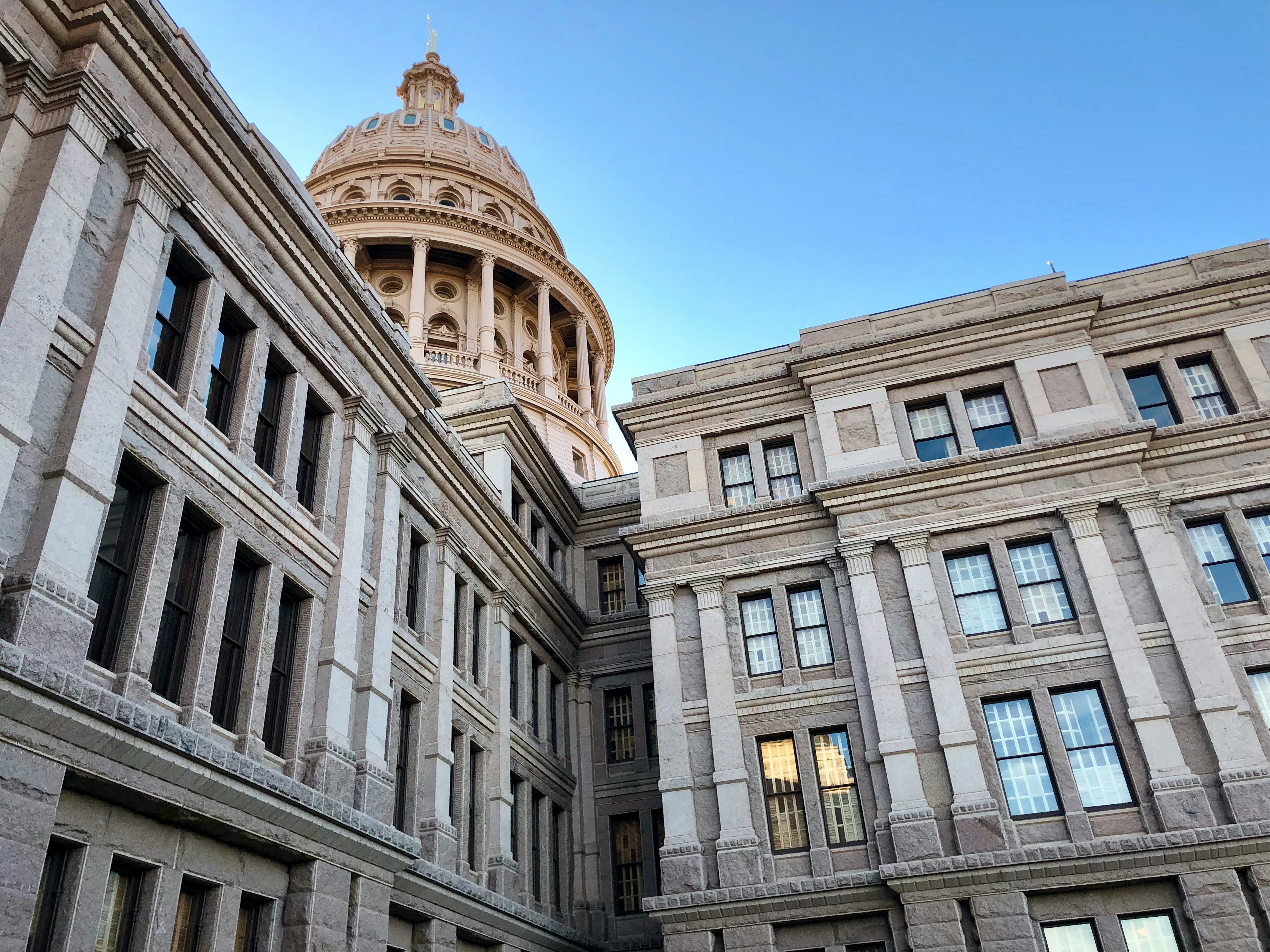 Image of a government building with a blue sky, symbolizing the exploration of governance and modern political systems.